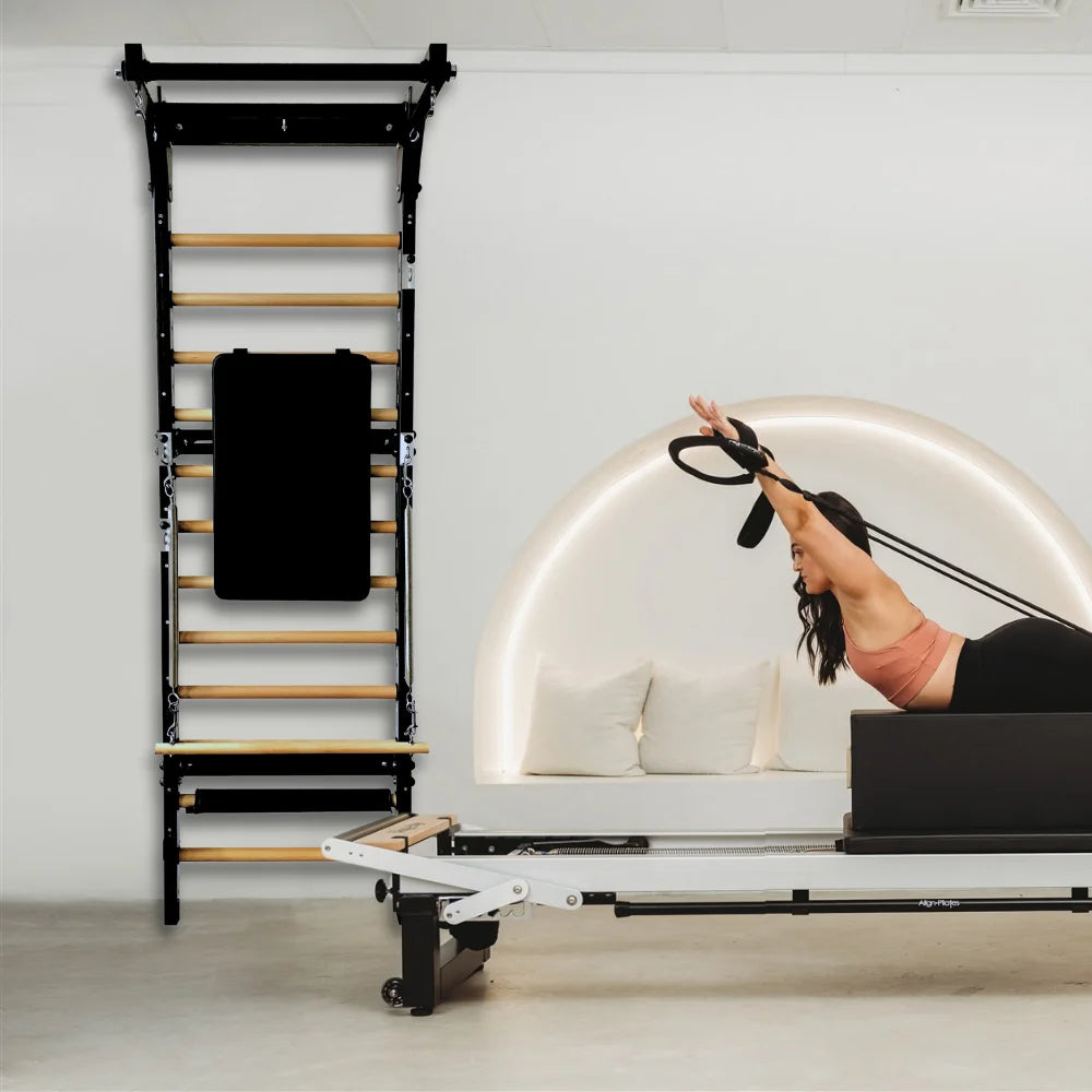 Woman exercising on a reformer next to a wall ladder
