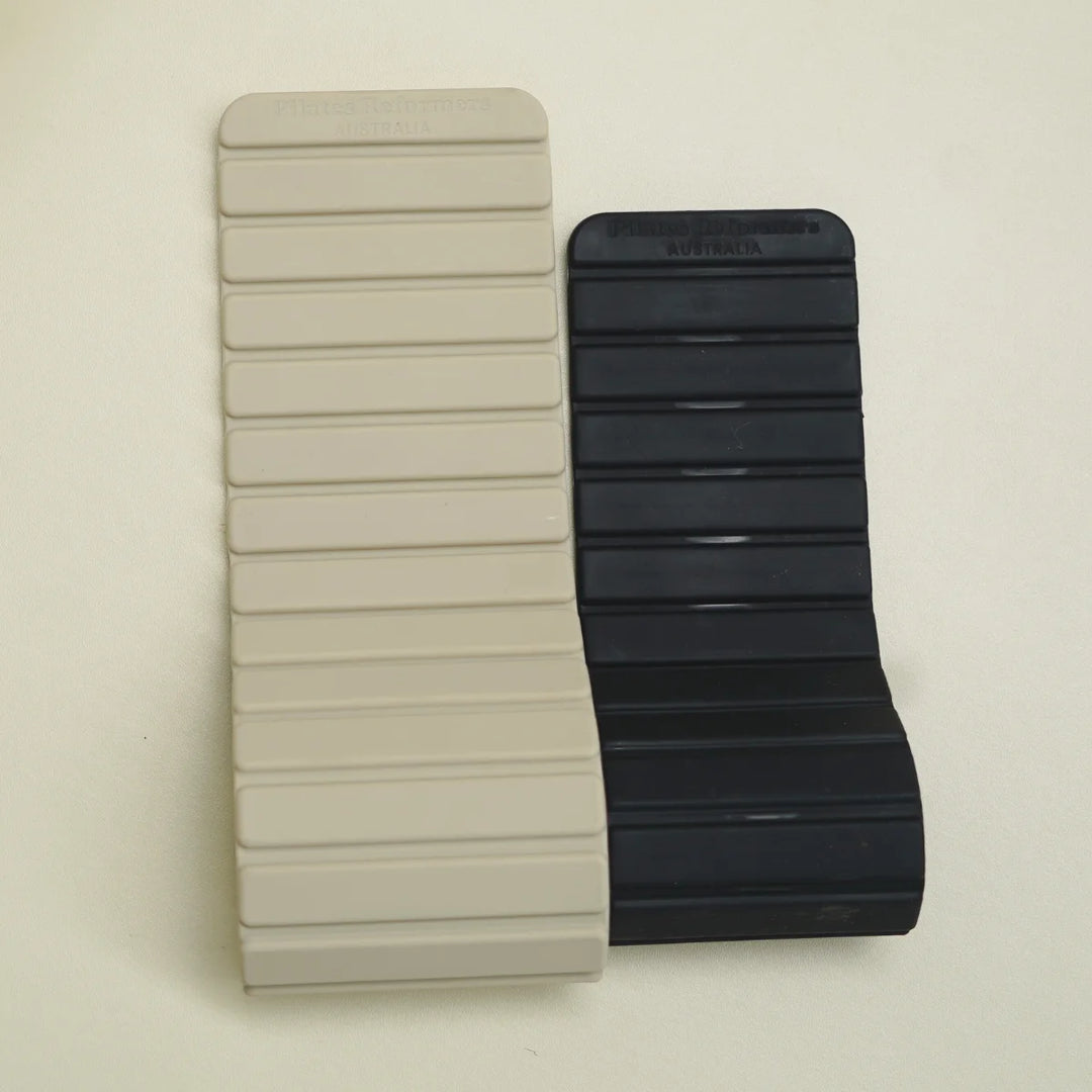 Two silicone magnetic bracelets, one beige and one black.