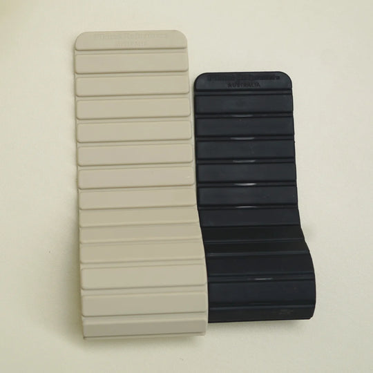 Two silicone magnetic bracelets, one beige and one black.