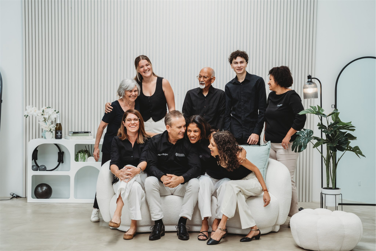 Group of people posing together in a modern living room setting.